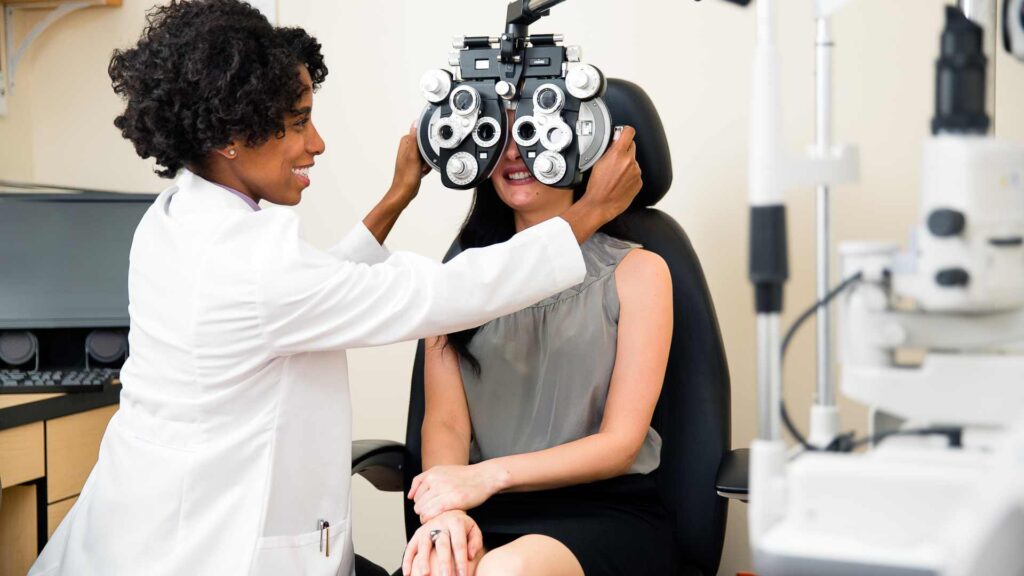 Optometrist in Tacoma performing a vision test using a phoropter on a patient for accurate eye examination